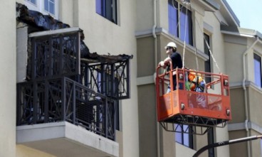Workmen examine the damage at the scene of the balcony collapse in Berkeley. 
